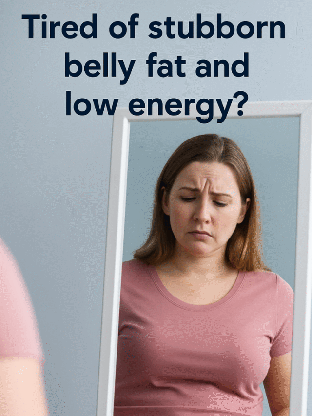 A woman looks at herself in the mirror disappointed, expressing discomfort with her stomach or weight.